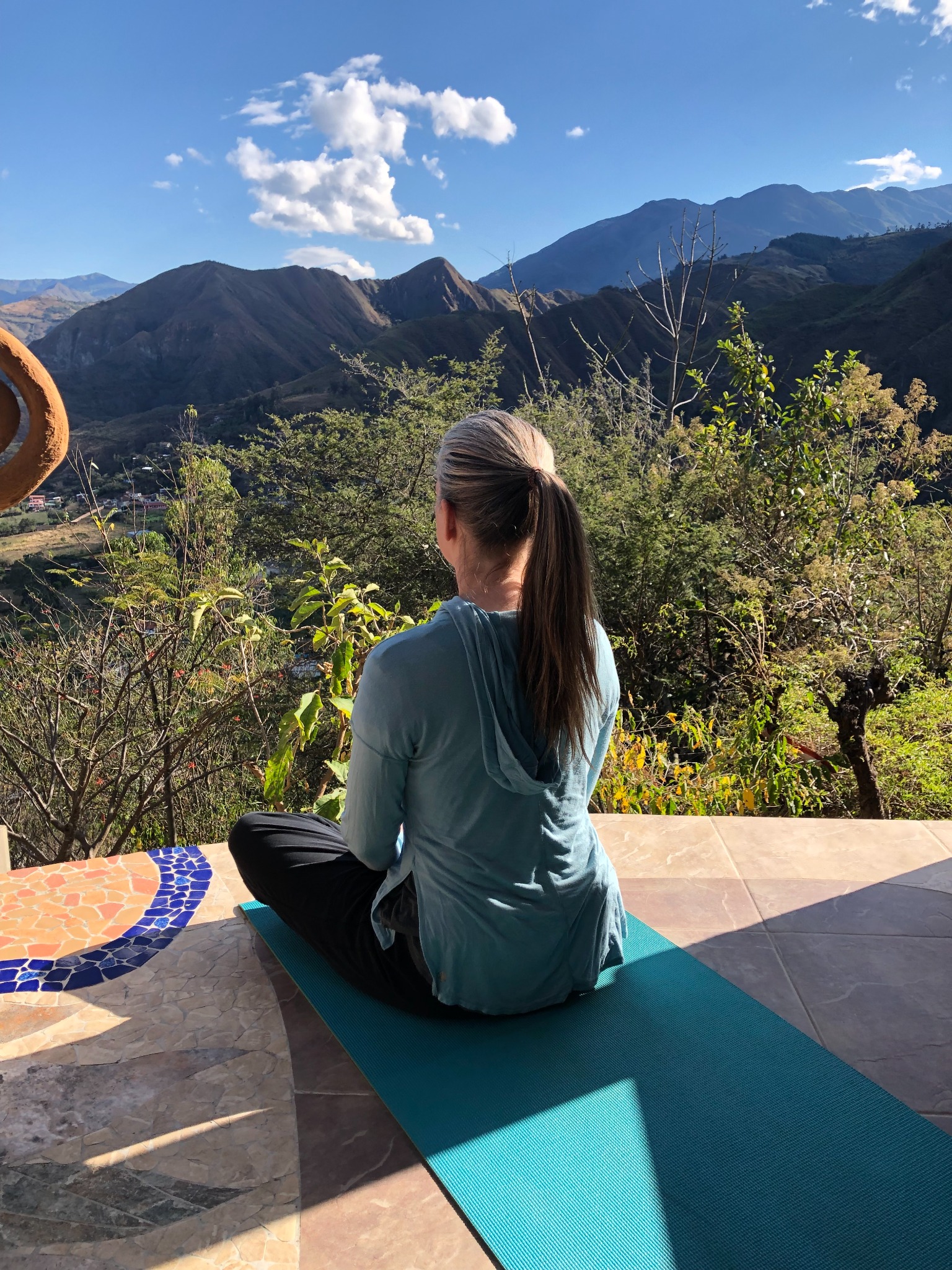 Shannon meditating while looking across the mountains of Ecuador